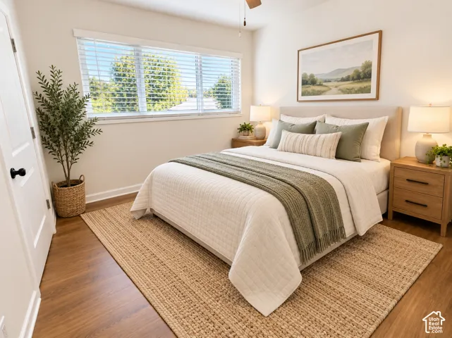 Room featuring wide-plank wood-finish flooring, a large horizontal window with horizontal blinds, and a ceiling fan with light fixture