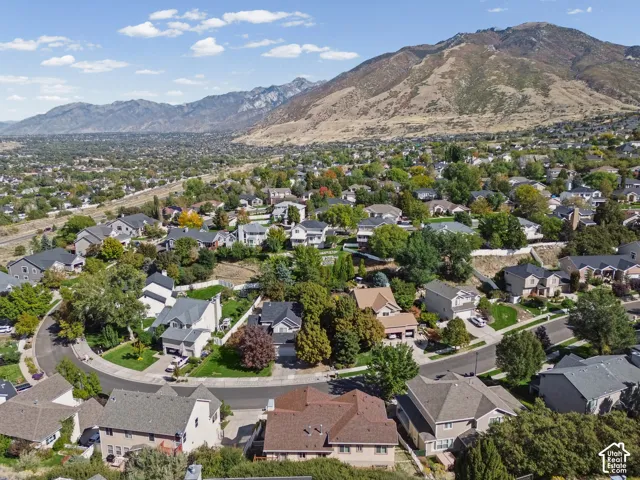Neighborhood setting with varied residential architecture and surrounding mountains