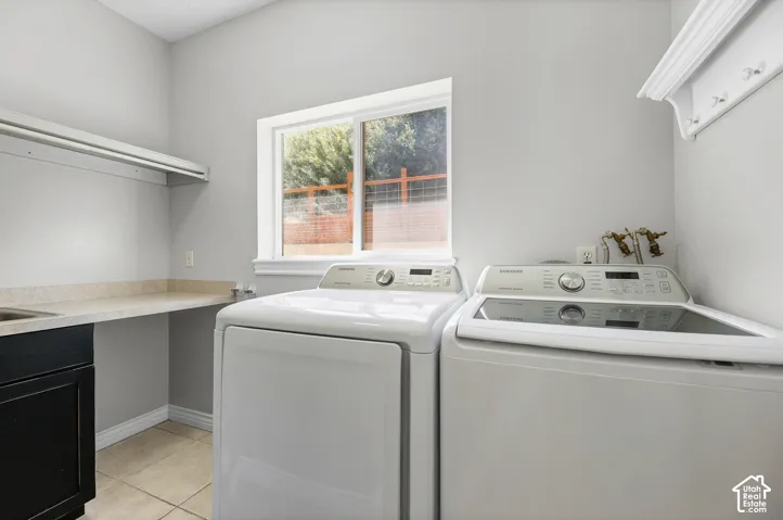 Laundry area with a window, built-in shelving, a utility sink, and ample countertop space
