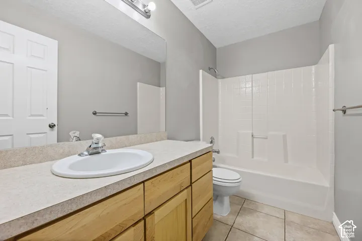 Light-toned wood-finish vanity with an integrated sink and chrome faucet