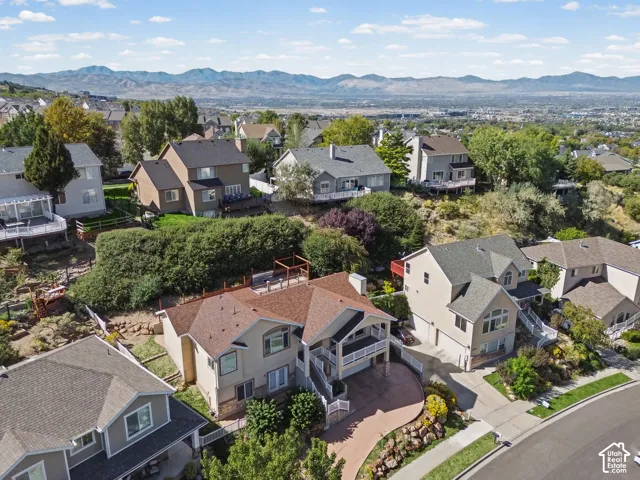 Hillside residential area featuring multiple detached homes with mountain backdrop