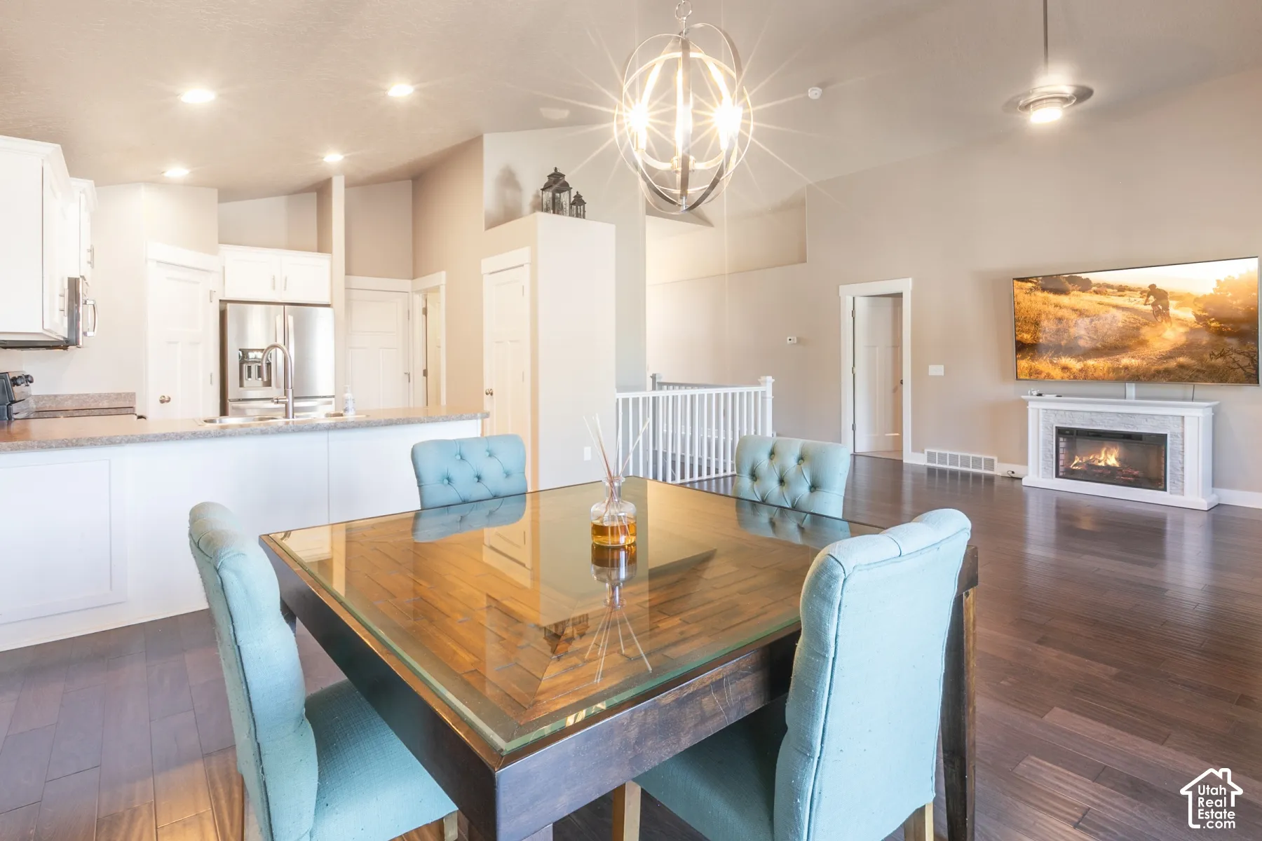 Vaulted ceilings with a decorative chandelier and recessed lighting