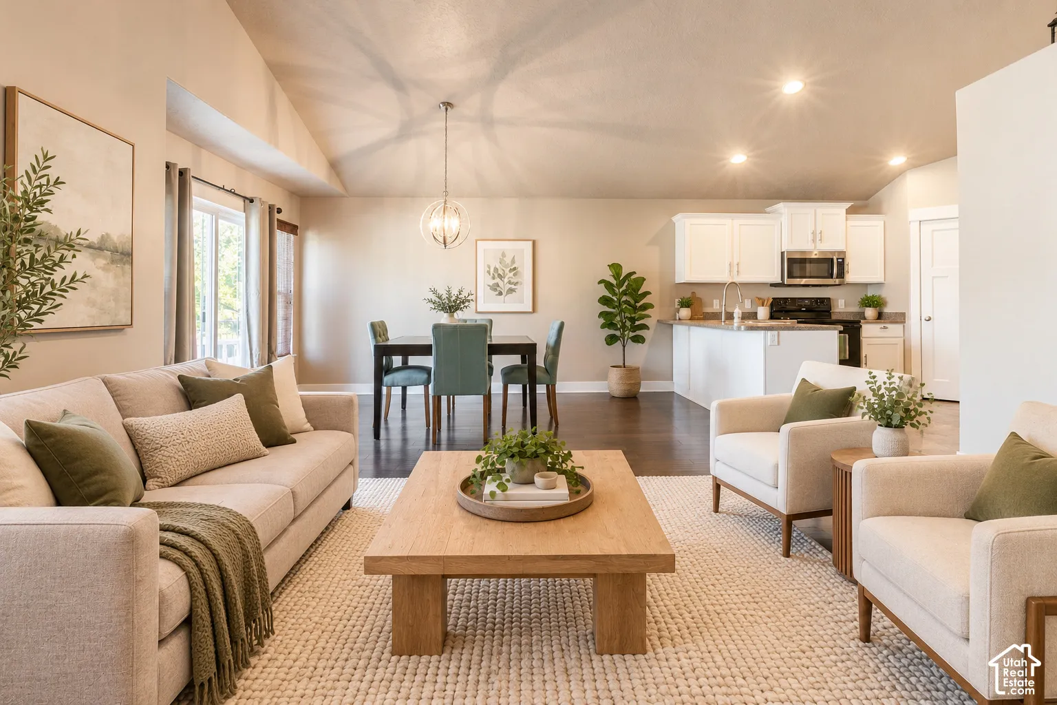 Vaulted ceilings, wood-finish flooring, white cabinetry, recessed lighting, and a kitchen island with a single-basin sink