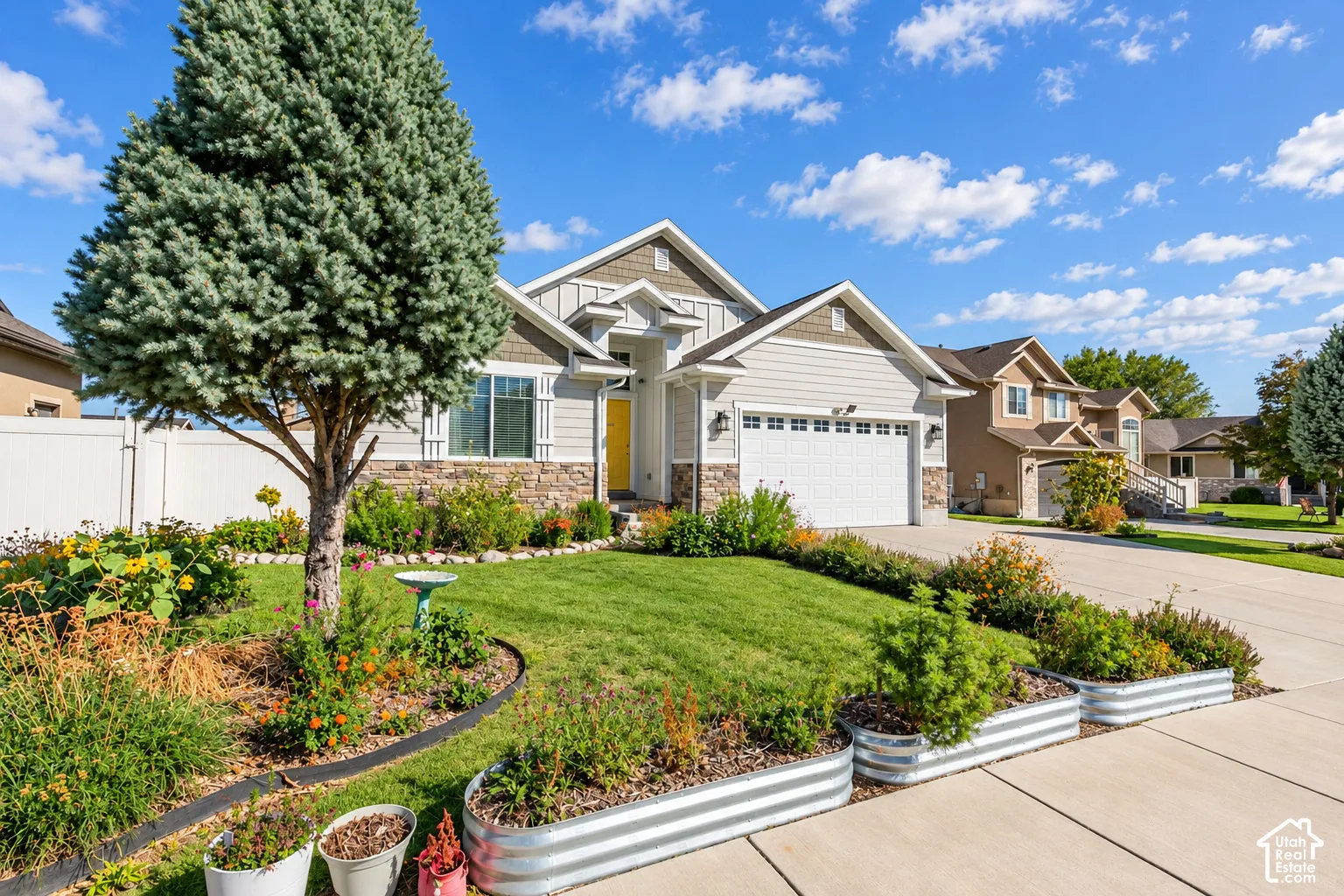 Light gray siding with stone veneer accents and white trim