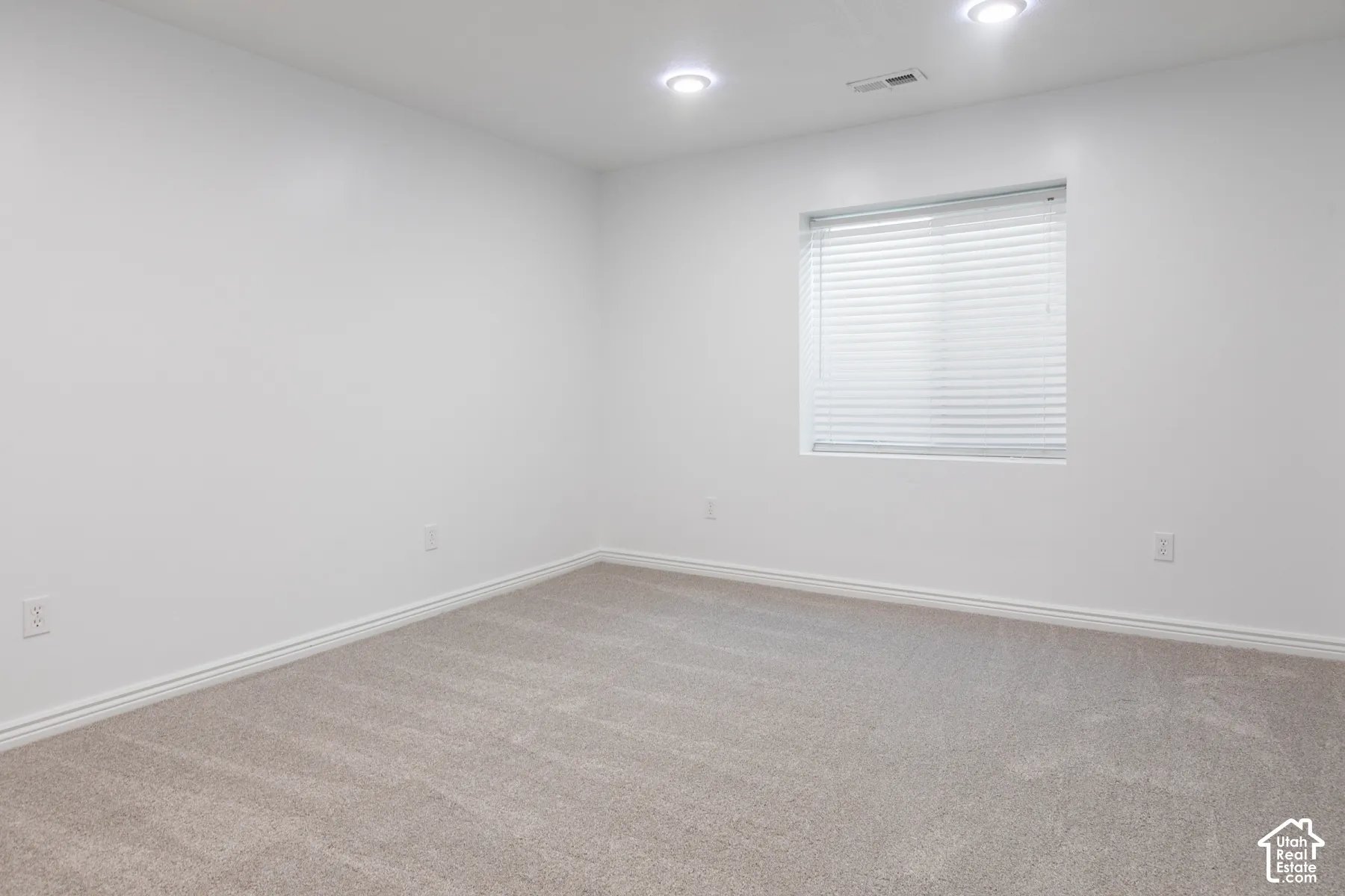 Recessed lighting, carpeted flooring, window with blinds, and white walls