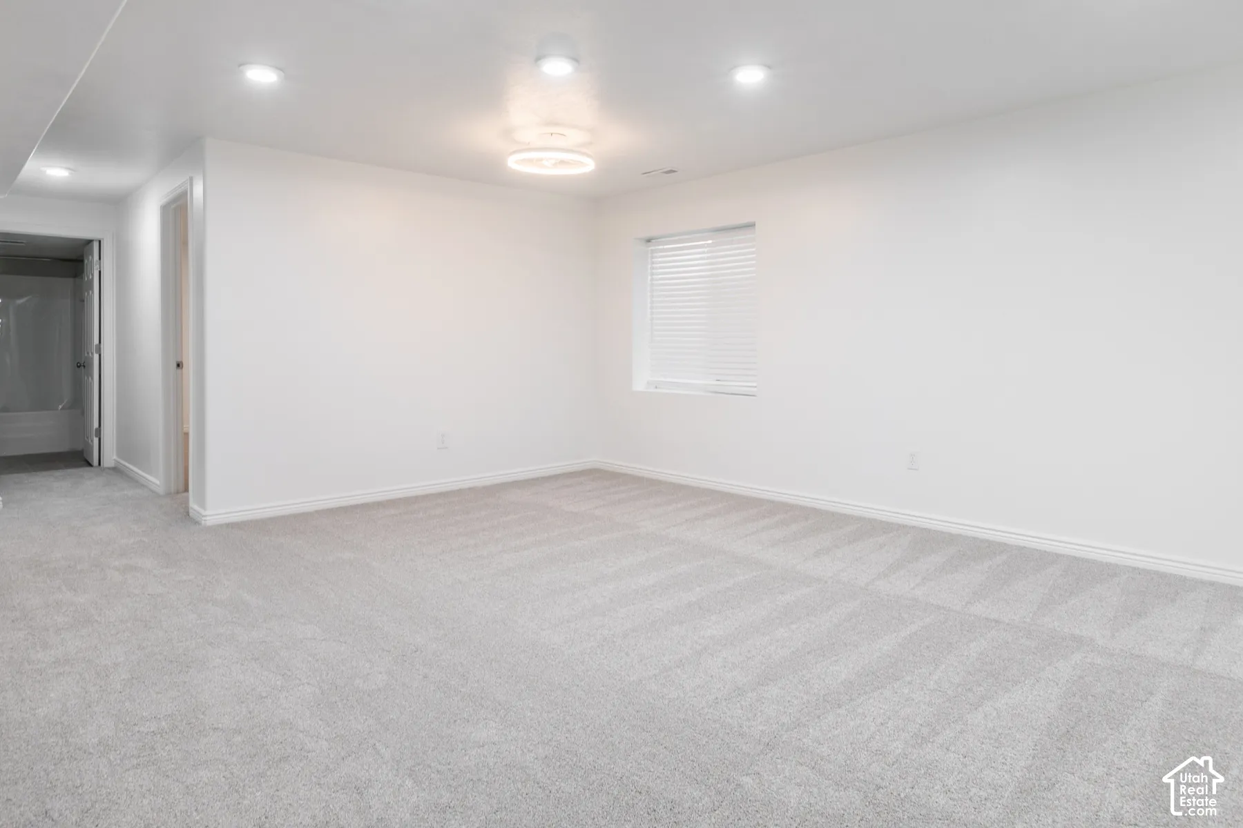 White interior walls and light gray carpet