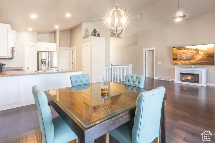 Vaulted ceilings with a decorative chandelier and recessed lighting