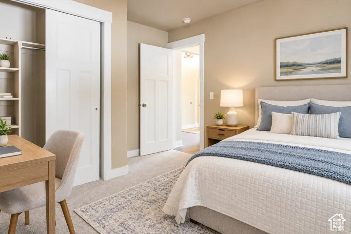 Recessed lighting, light-toned carpeting, and a built-in closet with sliding doors