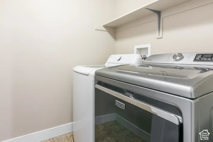 Laundry area featuring a utility shelf and light-colored walls