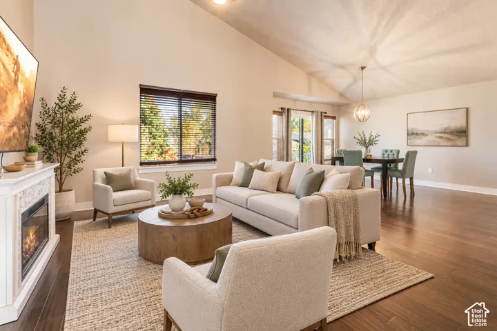 Vaulted ceilings and wood-finish flooring complement the electric fireplace with a stone surround