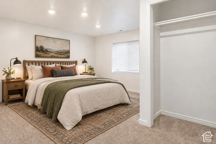 Recessed lighting, window with blinds, and built-in closet with hanging rod