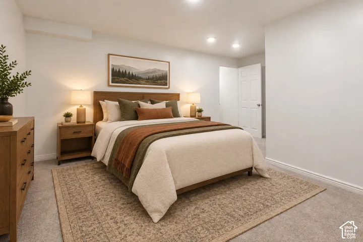 Primary Bedroom with wood-finish nightstands, recessed ceiling lighting, and neutral carpeting throughout