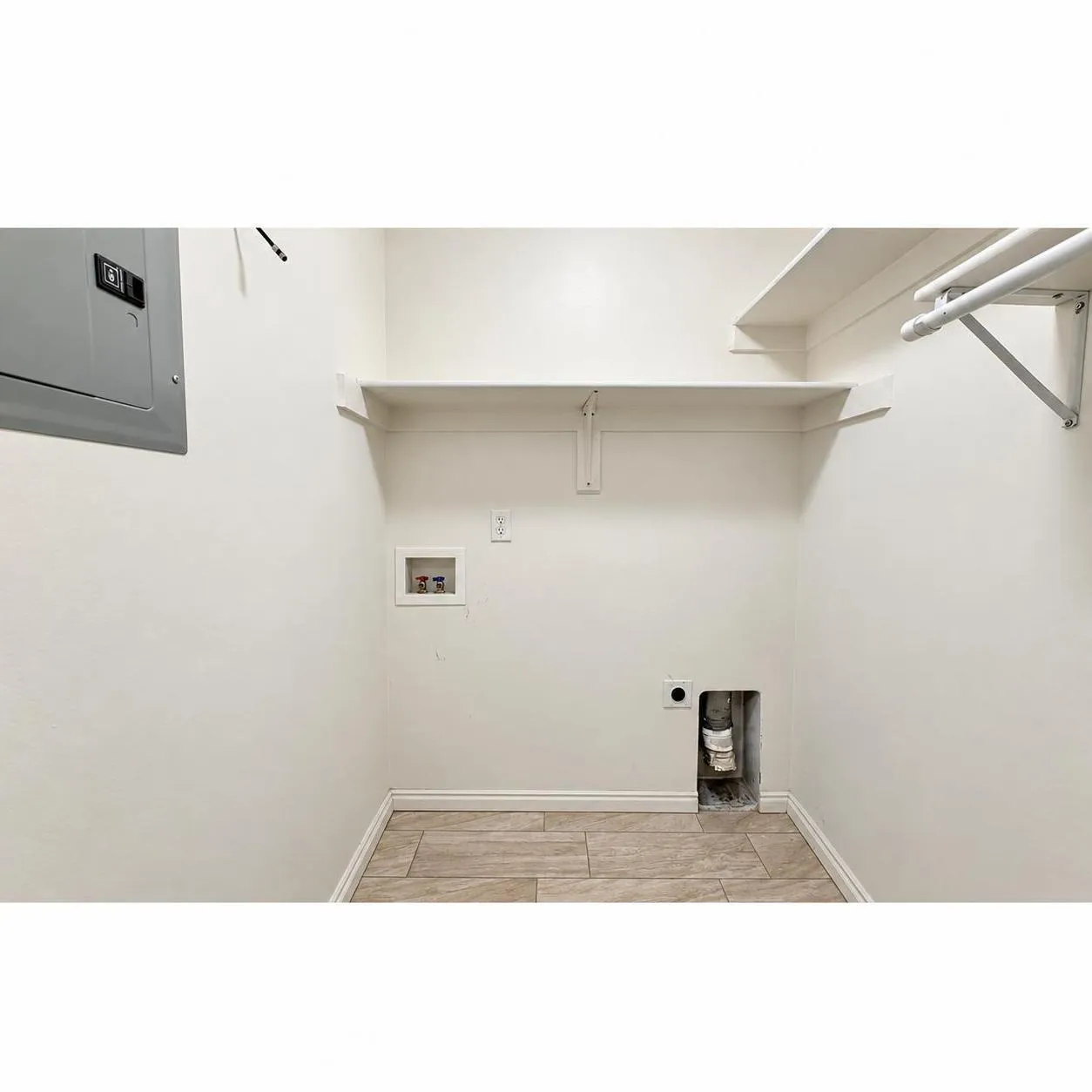 Built-in shelving, laundry hookups, and tiled flooring