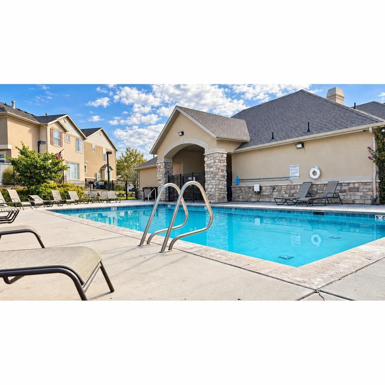 Resort-style swimming pool with concrete surround and direct building access