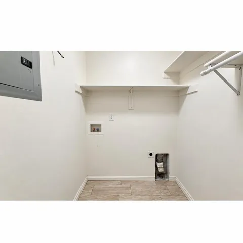 Built-in shelving, laundry hookups, and tiled flooring