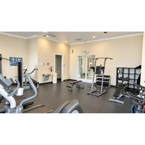 Fitness center with durable rubber flooring and a variety of exercise equipment