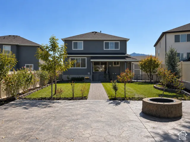 Stamped concrete patio featuring a built-in stone fire pit