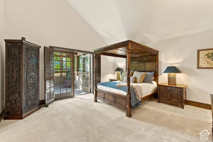 Vaulted ceiling, light-toned carpeting, wood-finish double doors, and a wood-finish armoire
