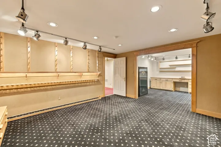 Expansive room featuring recessed lighting and track lighting fixtures