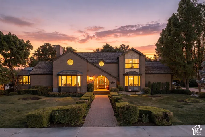 Brick exterior with a prominent arched entry, multiple bay windows, and circular accent windows