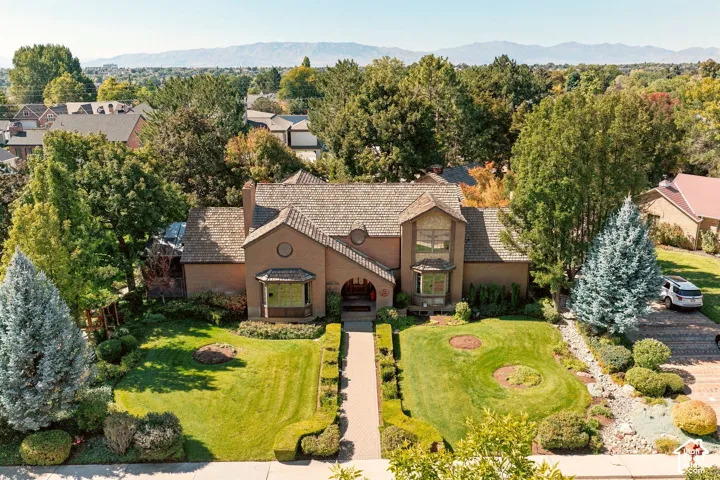 Brick exterior residence featuring a tiled roof and arched entry