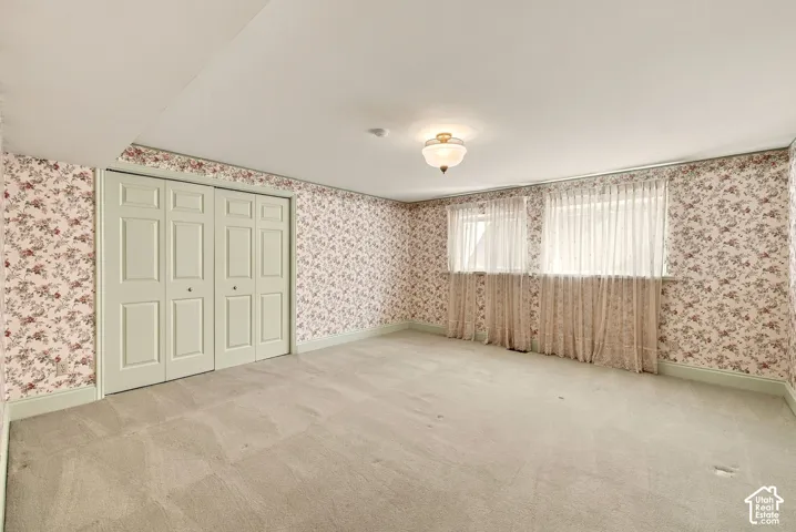 Recessed lighting, flush mount ceiling light fixture, bi-fold closet doors, wall-to-wall carpeting, and multiple windows