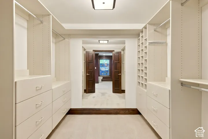 Custom closet system with integrated shelving, drawers, and hanging rods