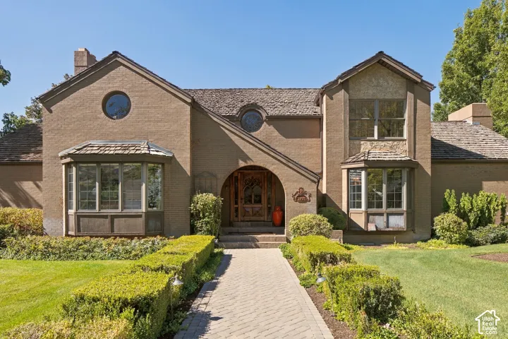 Brick exterior facade with multiple gables and two prominent bay windows