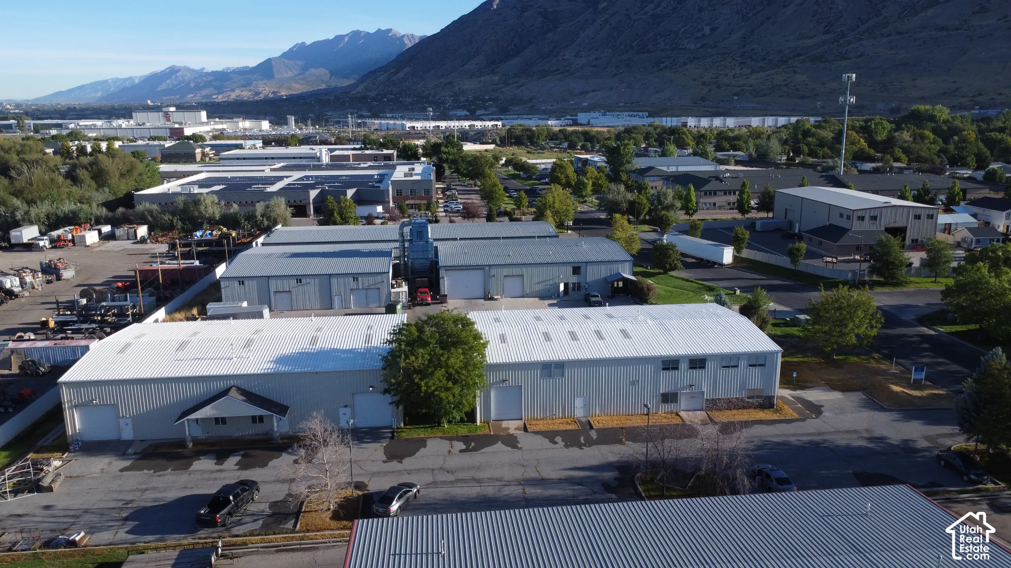 Multiple single-story industrial buildings featuring metal siding and gable roofs