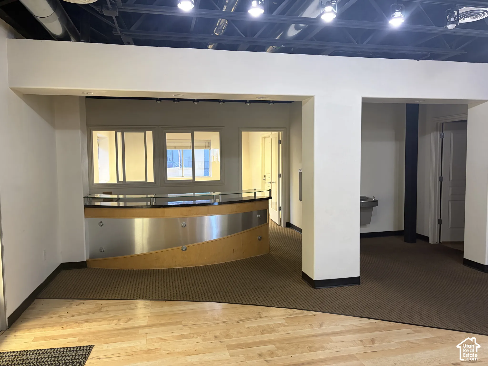 Custom built-in reception desk with a polished top and wood-finish paneling