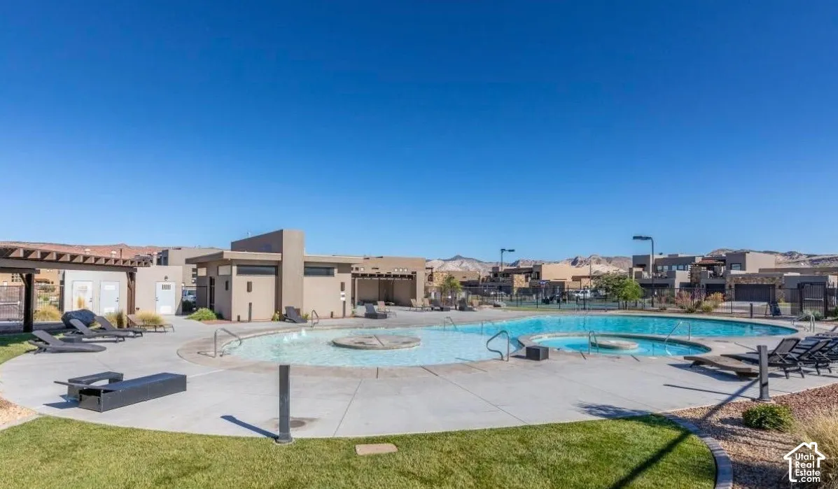 Expansive outdoor pool area with integrated spa