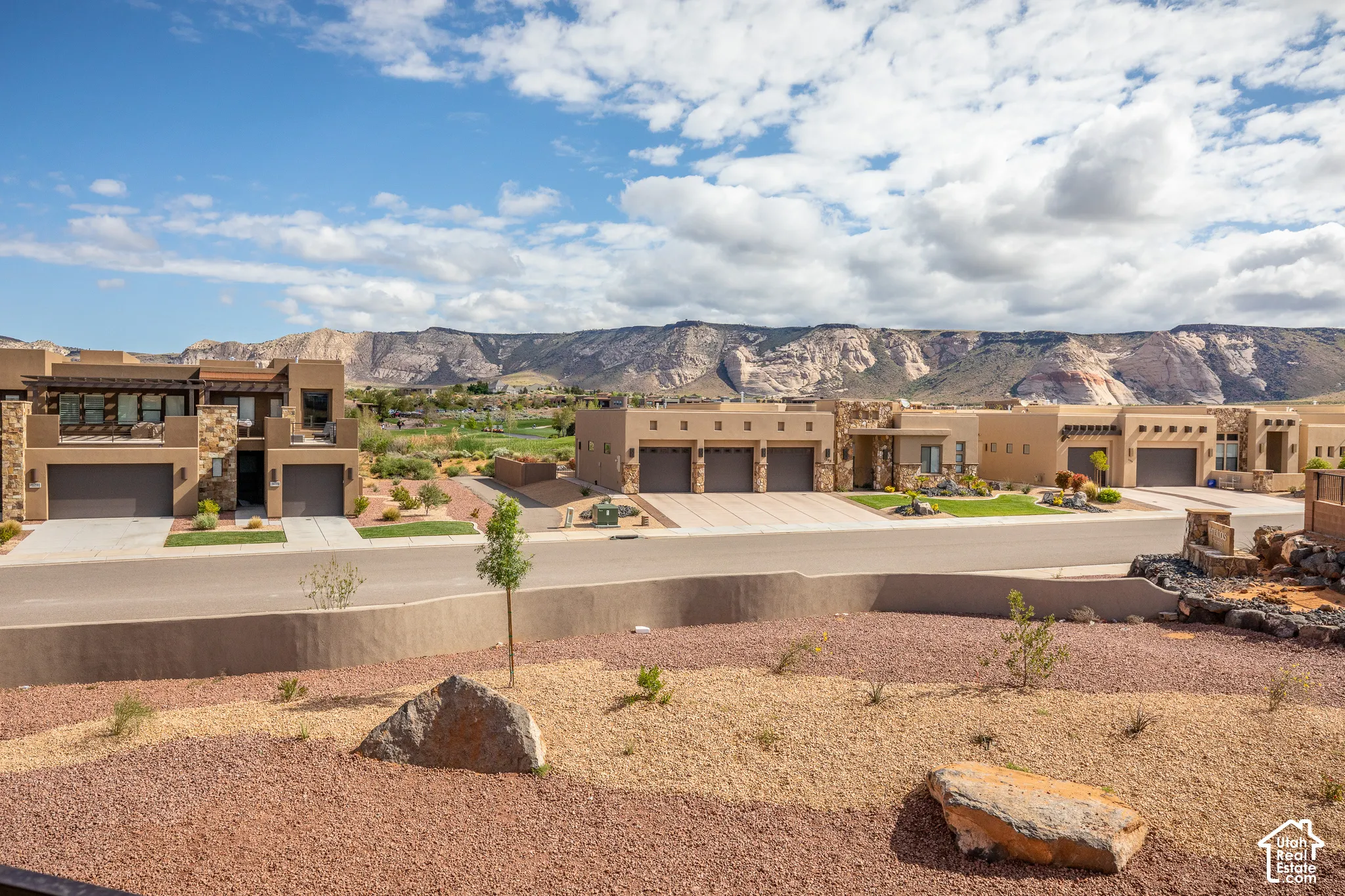 Desert landscaping with natural rock features and mature shrubbery