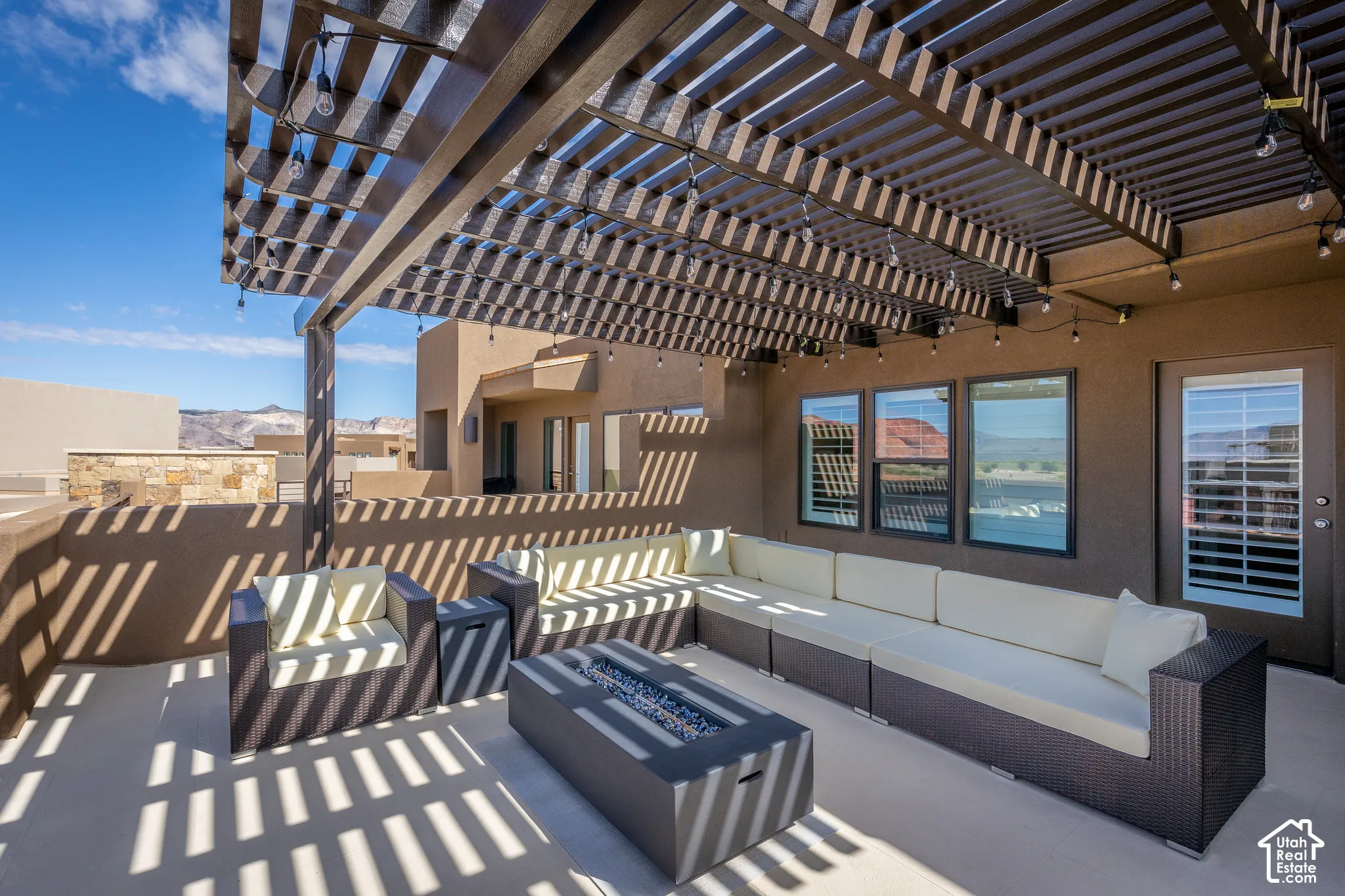 Rooftop patio with pergola and fire pit.