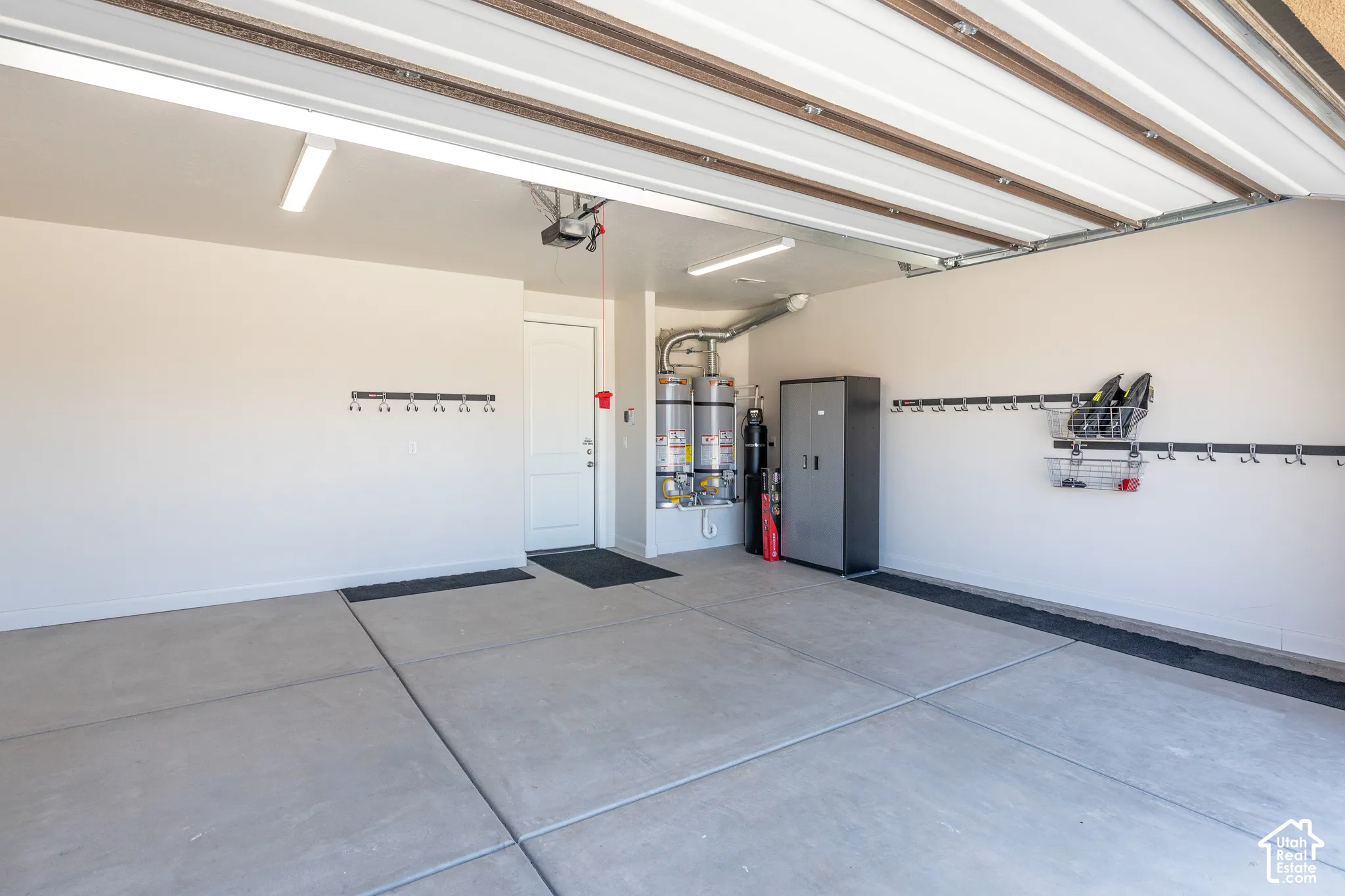 Spacious garage with light-colored walls and concrete flooring