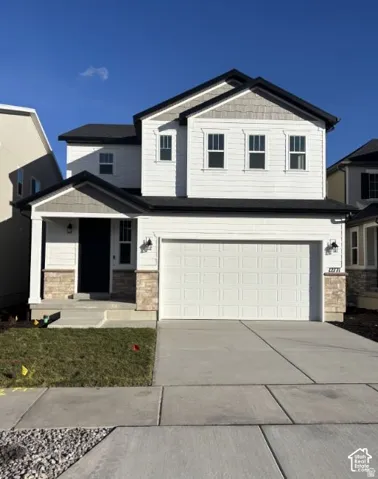 Two-story residence featuring white siding and gray shake accents