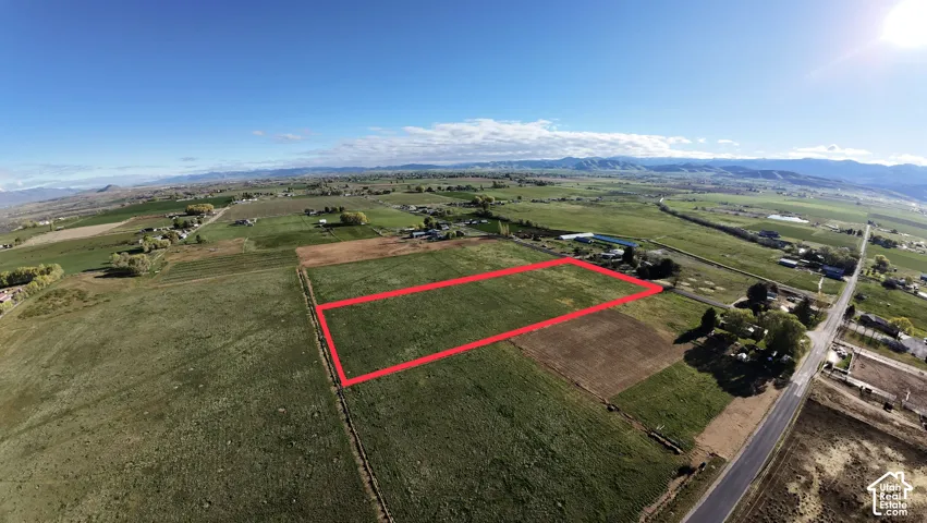 Expansive lot featuring a grassy field and distant mountain scenery