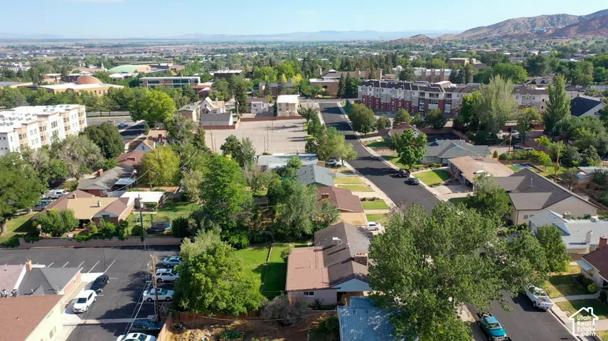 Residential neighborhood with mature trees and paved streets, featuring a mix of single-story and multi-story homes