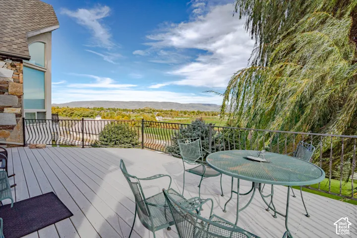 Expansive outdoor deck with composite decking and wrought iron railing
