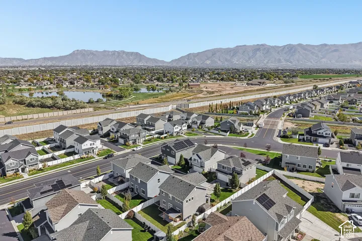 Aerial perspective showcasing a residential community with varied rooflines and solar panels on select homes