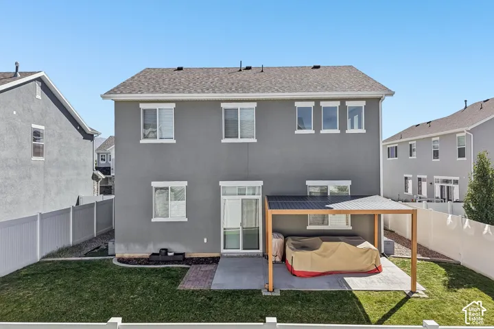 Rear exterior with stucco finish and a multi-level roofline