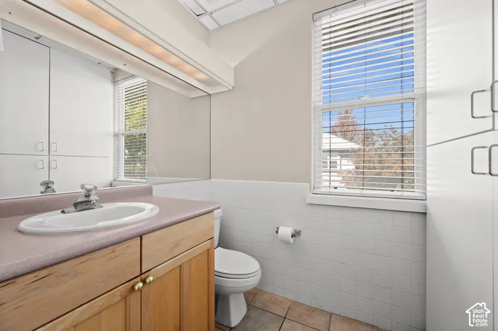 Wood-finish vanity with a drop-in sink and chrome faucet