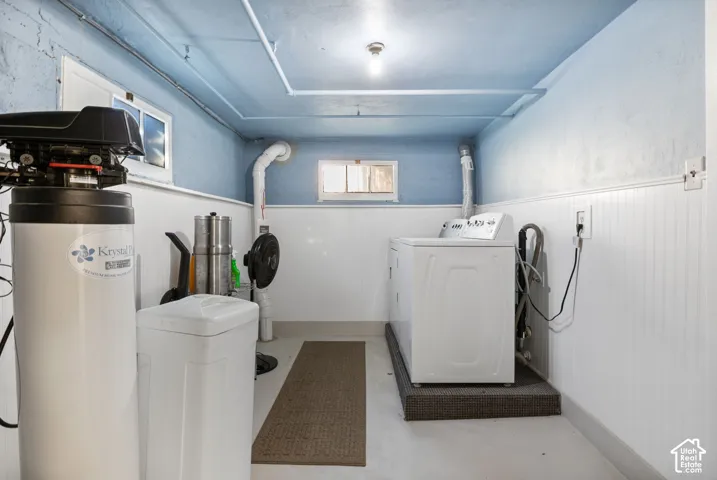 Utility space and laundry room with included washer, dryer and water softener.