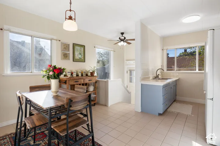 Kitchen with beautiful grey blue cabinetry and eat in dining space with access to the back door.