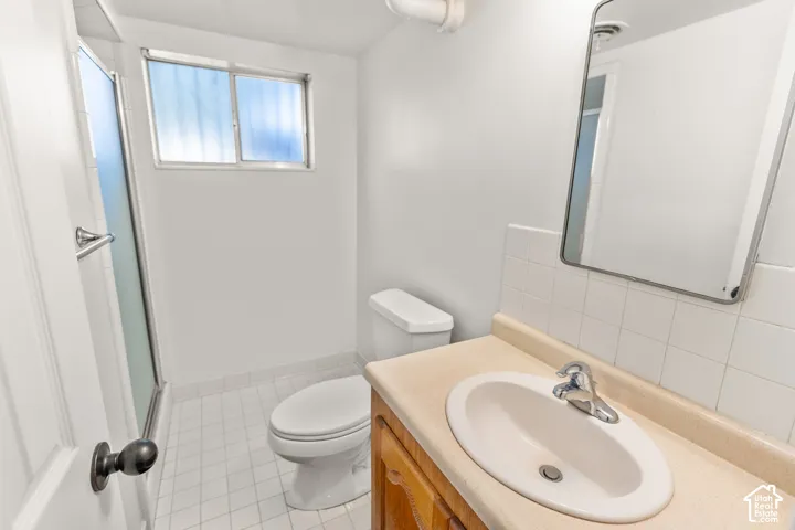 White tile flooring and a built-in vanity with an integrated sink