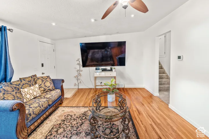 Wood-finish flooring, recessed lighting, and a ceiling fan