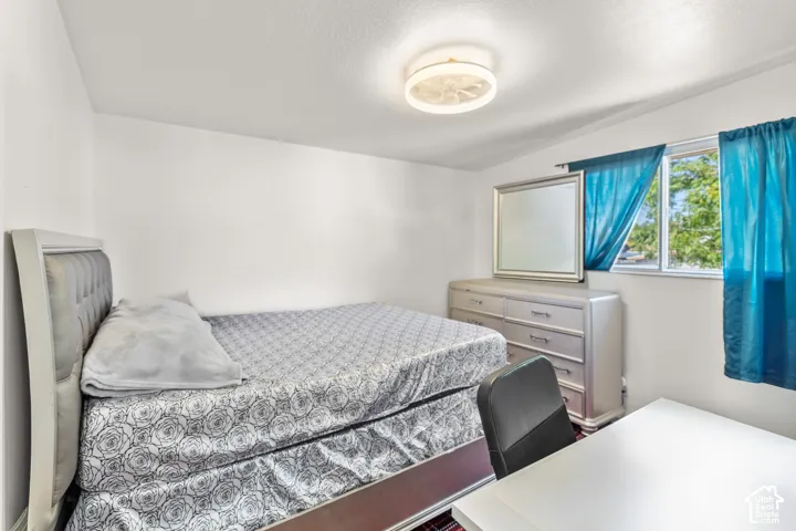Bright room featuring a window, overhead flush-mount lighting, and light-colored walls