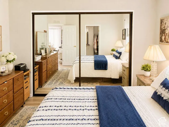 Mirrored sliding closet doors and light wood-finish flooring