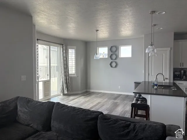 Open-concept living area with wood-finish flooring