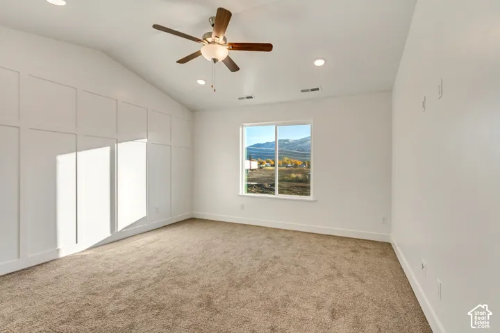 Vaulted ceiling with a ceiling fan and recessed lighting