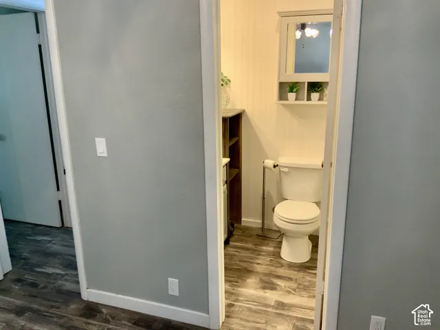 Wood-finish flooring with white trim and light gray walls